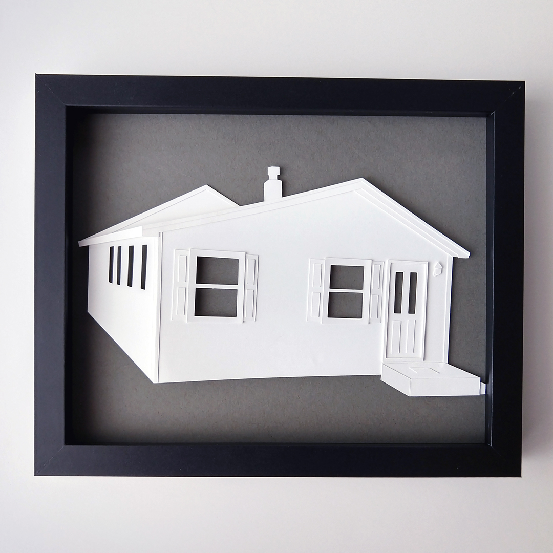 a paper cut out of a white house