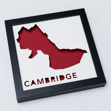 a black frame with a red cut out of the shape of a map