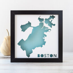 a framed map of boston with a light blue background