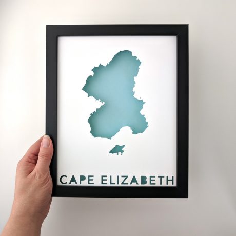 a person holding up a framed map of cape elizabeth