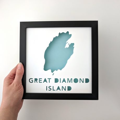 Framed map of Great Diamond Island, Maine with a light blue background held in hand