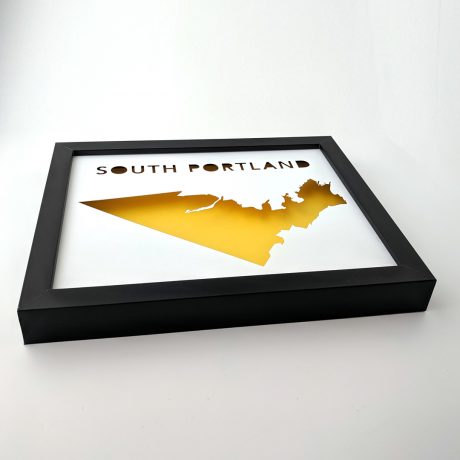 Angled view of South Portland map with yellow background in black frame