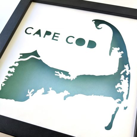 a black frame with a green and white map of cape