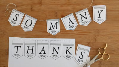 Partially-assembled printed "So Many Thanks" banner
