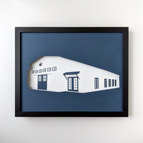 Framed paper art depicting the "Making It" barn in navy and white.