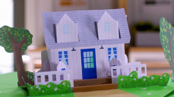 Still frame from the show's title sequence depicting a paper pop-up version of the cottage