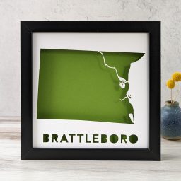 a black frame with a green map of Brattleboro, Vermont