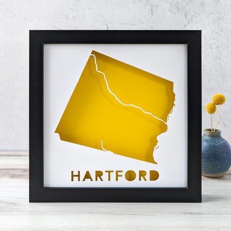 a framed yellow map of the town of Hartford, VT
