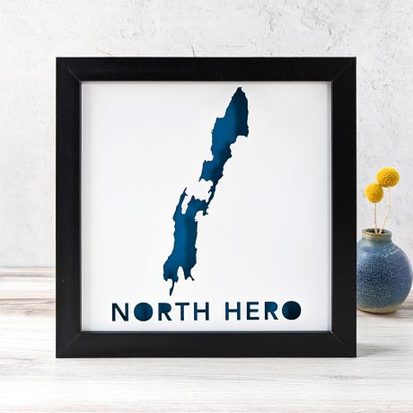 a framed blue and white map of North Hero island with the words north hero on it