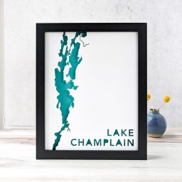 a framed lake champlain map on a table