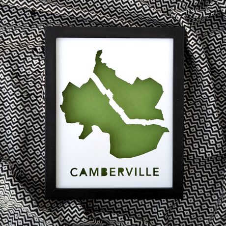 a black frame with a green map of Camberville on a patterned black and white background