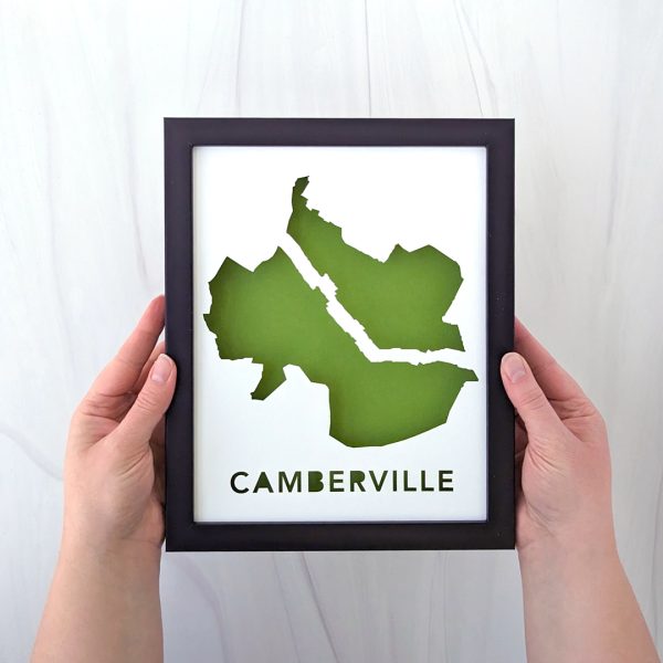 someone holding up a framed map of Camberville, MA (Cambridge and Somerville)