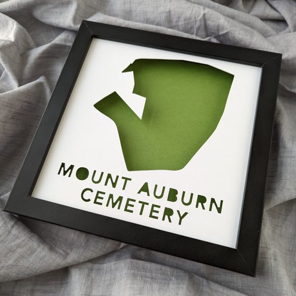 A framed map of Mount Auburn Cemetery with a green background