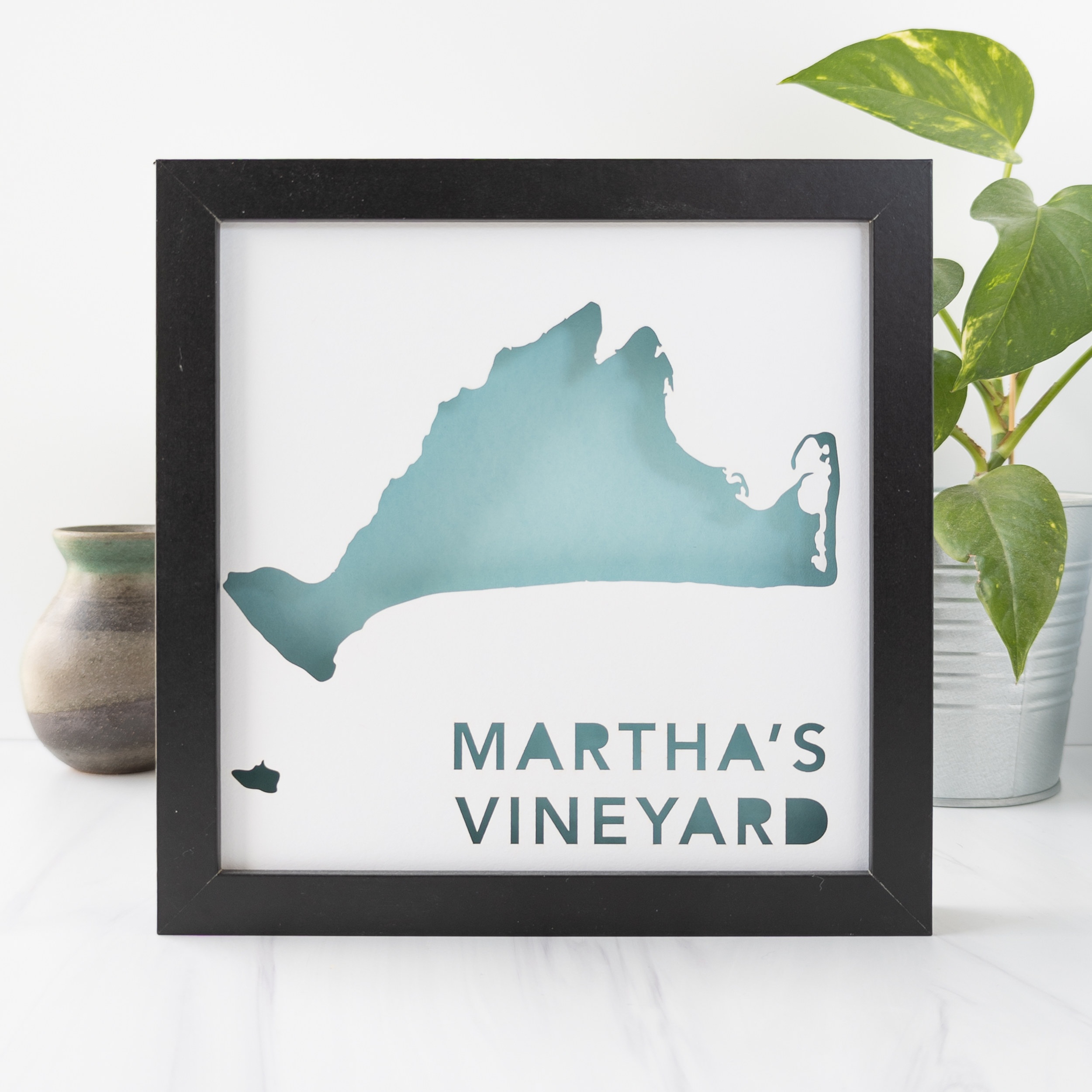 a black frame with a blue cut-out map of Martha's Vineyard