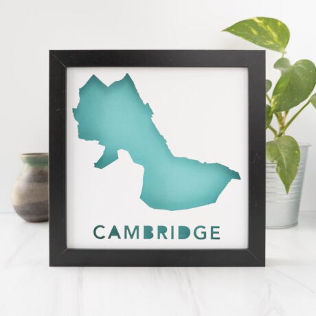 a black frame with a blue map of Cambridge, MA