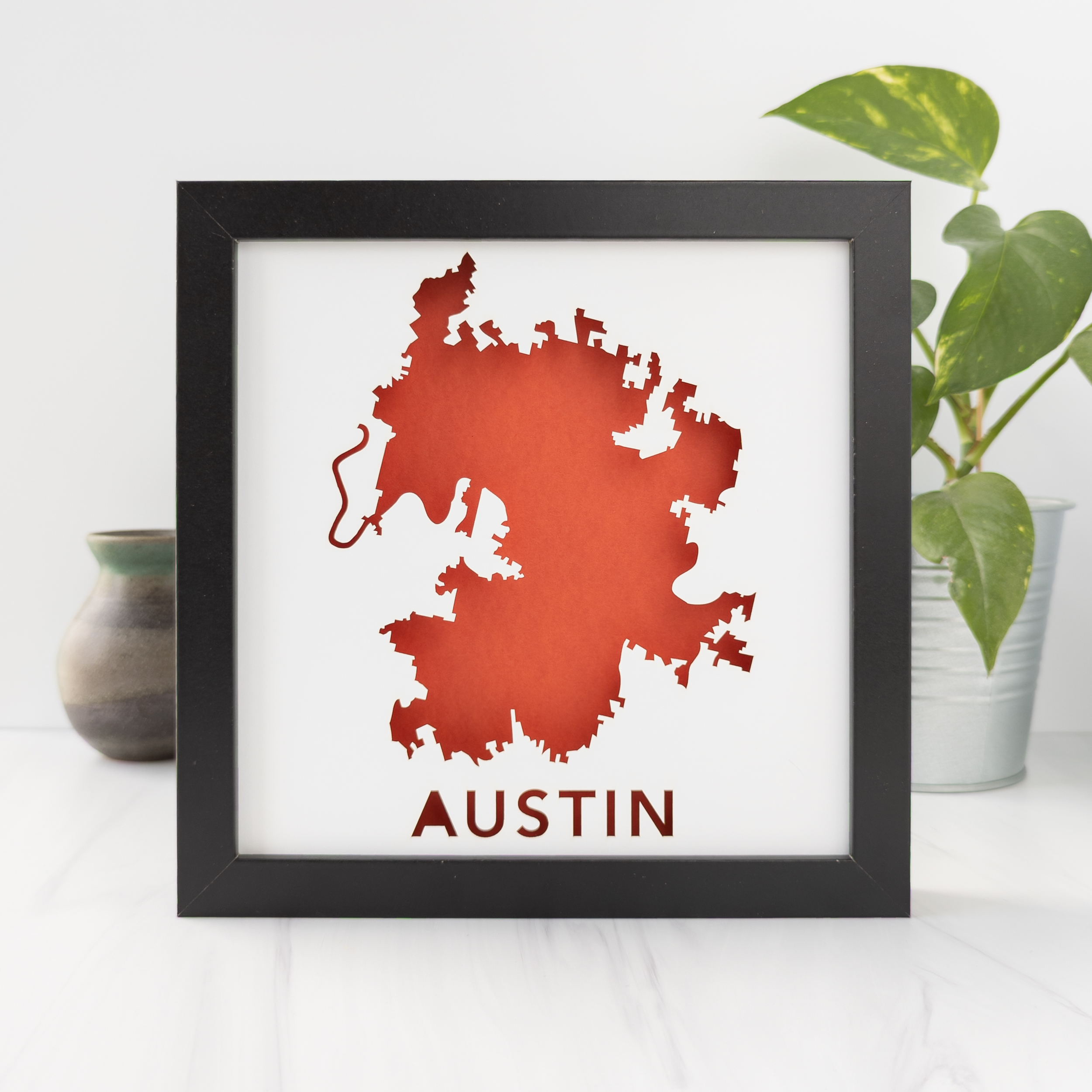 a framed map of the city of Austin, TX in orange