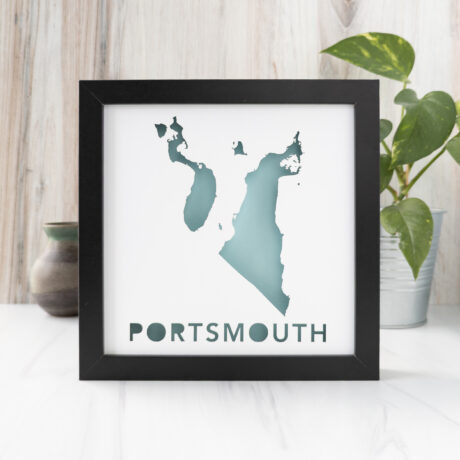 a black frame depicting a map of Portsmouth, RI sitting on top of a table
