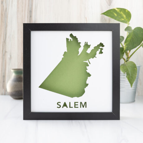 a framed map with the shape of Salem, MA on it