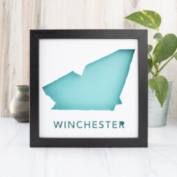 a framed paper cut map of Winchester, MA