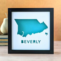 a black frame with a teal blue map of beverly
