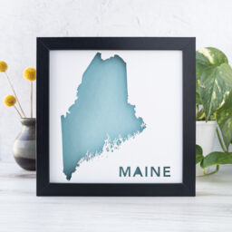 a framed blue and white map of the state of Maine