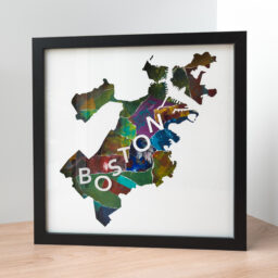 A framed map of Boston, MA with a colorful collaged background of greens, reds, and blues