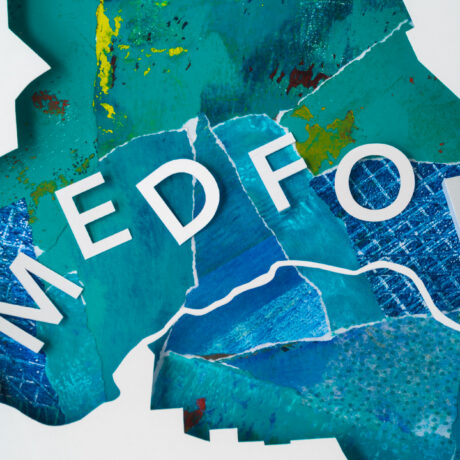 A closeup of the blue and green collaged background of the Medford map with the letters "MEDFO" visible