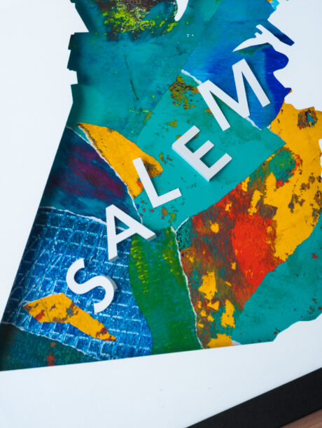 A close-up of the collaged background showing the letters "SALEM" and more detailed background colors and textures.