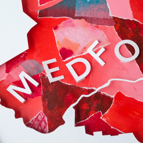 A closer view of the pink and red map of Medford, MA with the letters "MEDFO" visible