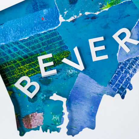 A close view of the blue collaged map of Beverly, MA with the letters "BEVER" visible