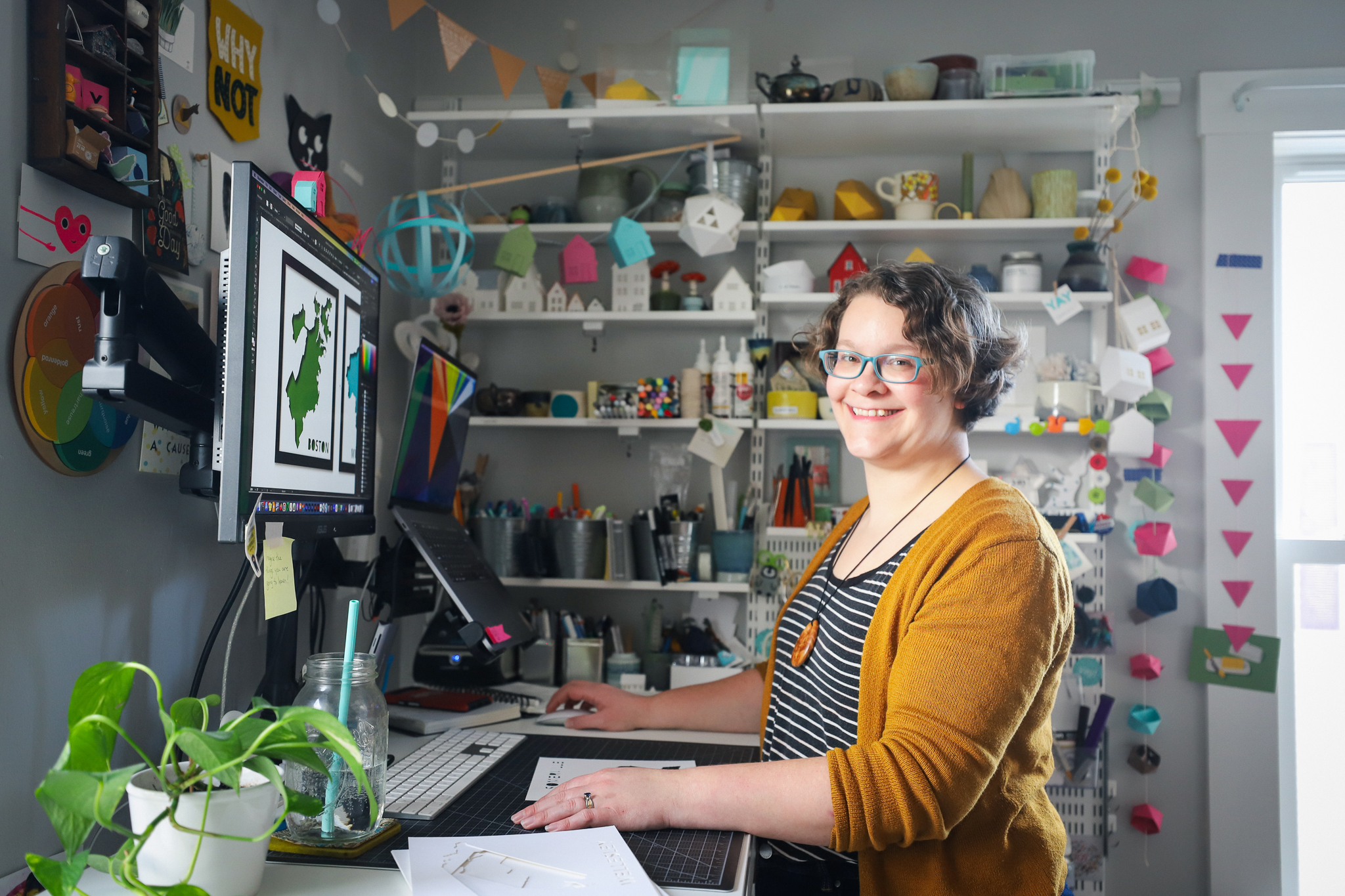 Artist Abigail McMurray in the yeiou paper objects studio, surrounded by works in progress, tools, and supplies